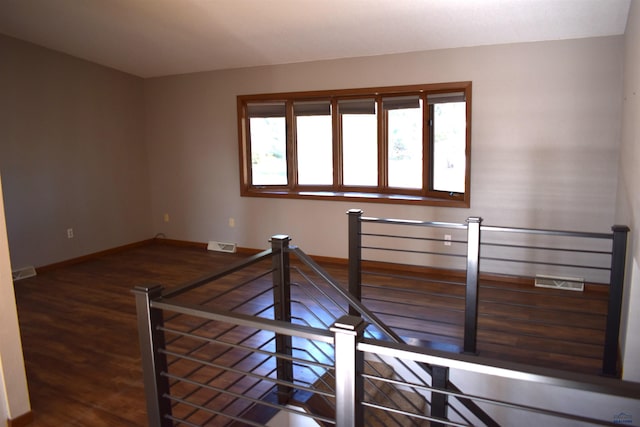 unfurnished room with hardwood / wood-style flooring