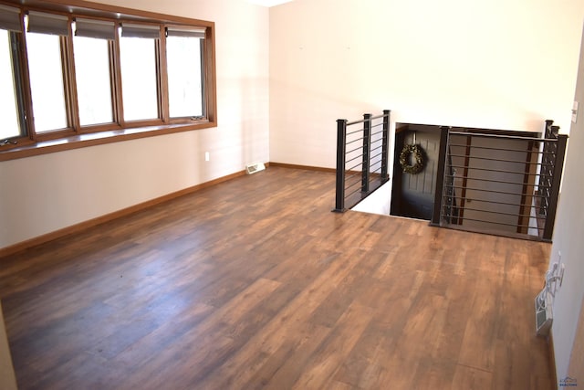 unfurnished room featuring dark wood-type flooring