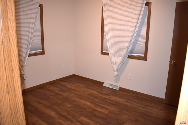 spare room with hardwood / wood-style floors