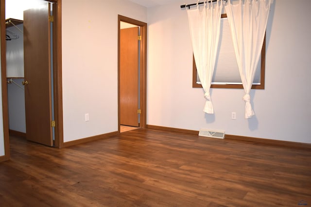 spare room with dark hardwood / wood-style floors