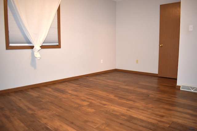 empty room with dark wood-type flooring