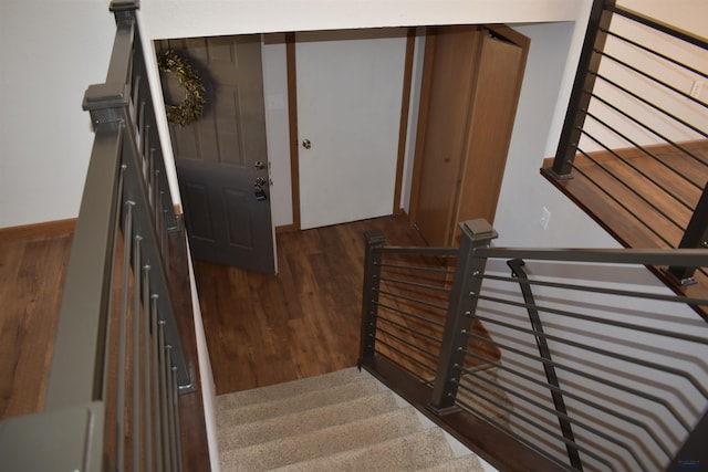 stairs with hardwood / wood-style floors