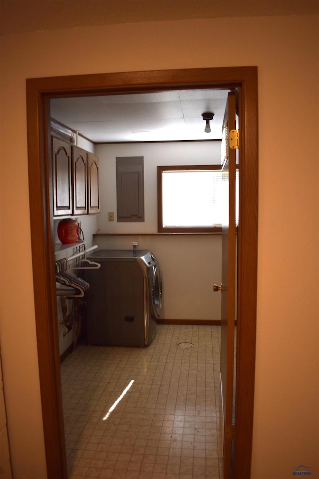 laundry room with washing machine and clothes dryer, cabinets, electric panel, and light tile patterned flooring