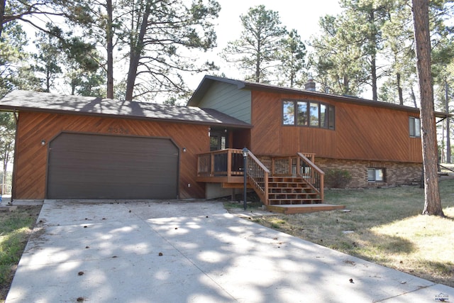 view of front of property with a garage and a front lawn