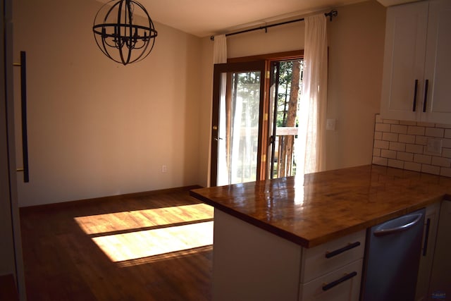 kitchen featuring hanging light fixtures, dark hardwood / wood-style floors, decorative backsplash, and a notable chandelier