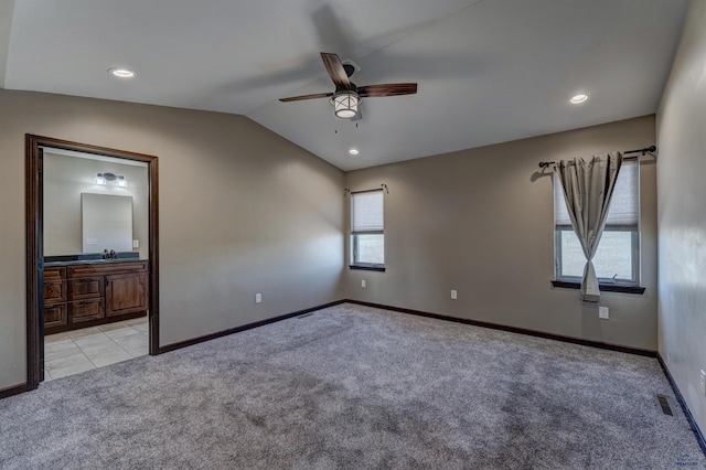 empty room with ceiling fan, sink, light carpet, and vaulted ceiling