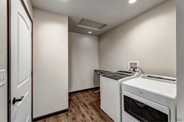 laundry room featuring hardwood / wood-style floors and washer and clothes dryer