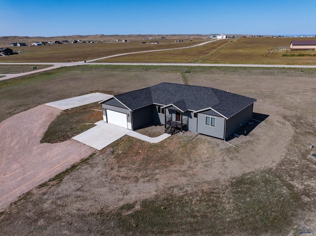 birds eye view of property with a rural view