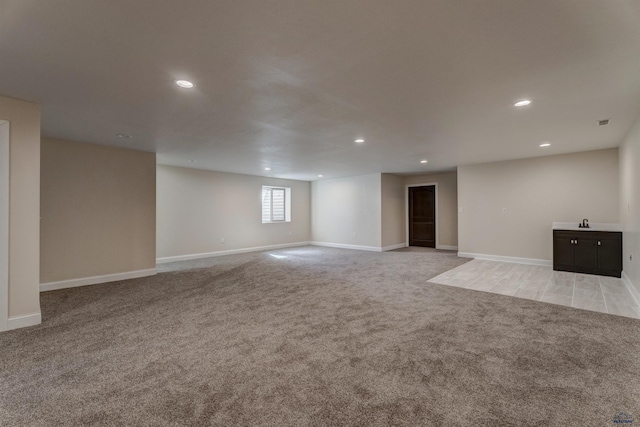 carpeted spare room featuring sink