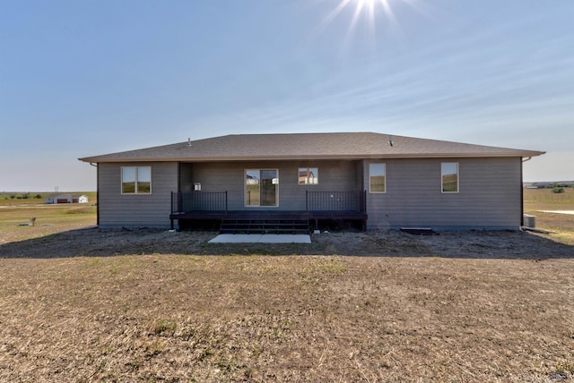 back of property featuring a yard and a deck