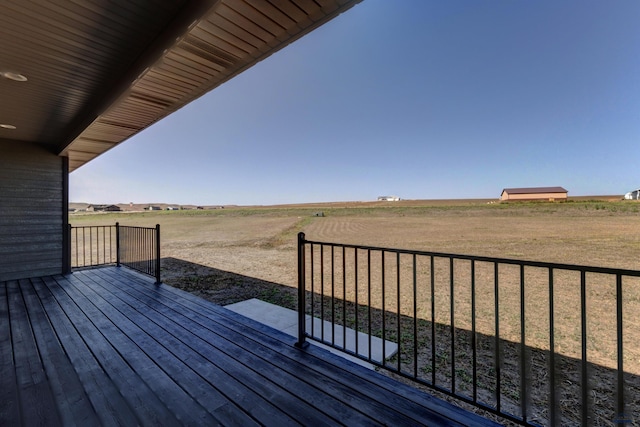 wooden terrace featuring a rural view