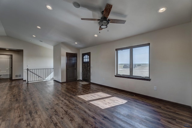 spare room featuring lofted ceiling, dark wood-type flooring, and ceiling fan