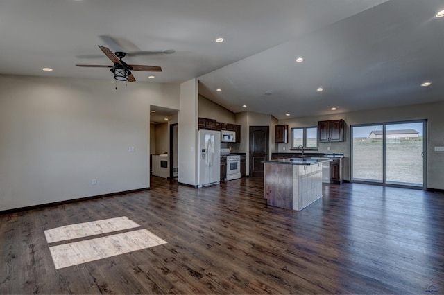 kitchen with a kitchen island, ceiling fan, dark hardwood / wood-style floors, and white appliances