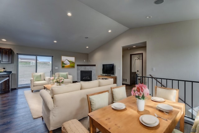 living room featuring lofted ceiling and dark wood-type flooring