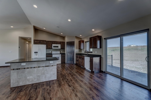 kitchen with vaulted ceiling, sink, white appliances, and dark hardwood / wood-style flooring