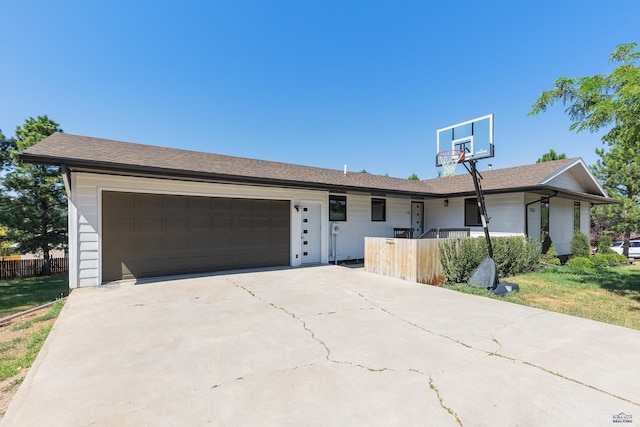 single story home featuring a garage and a front lawn