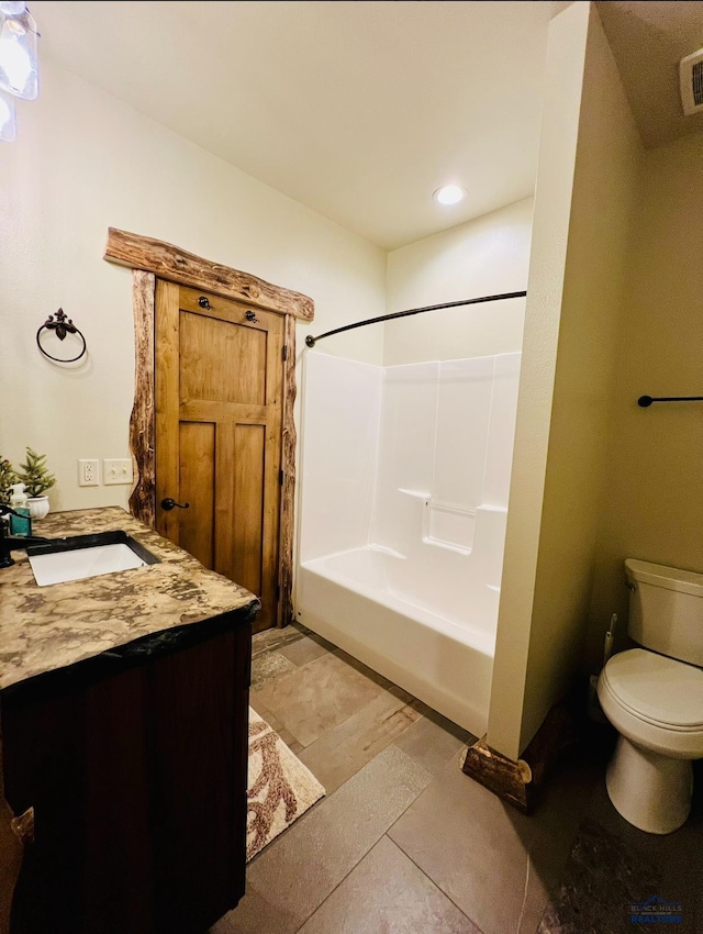 full bath with  shower combination, vanity, and toilet