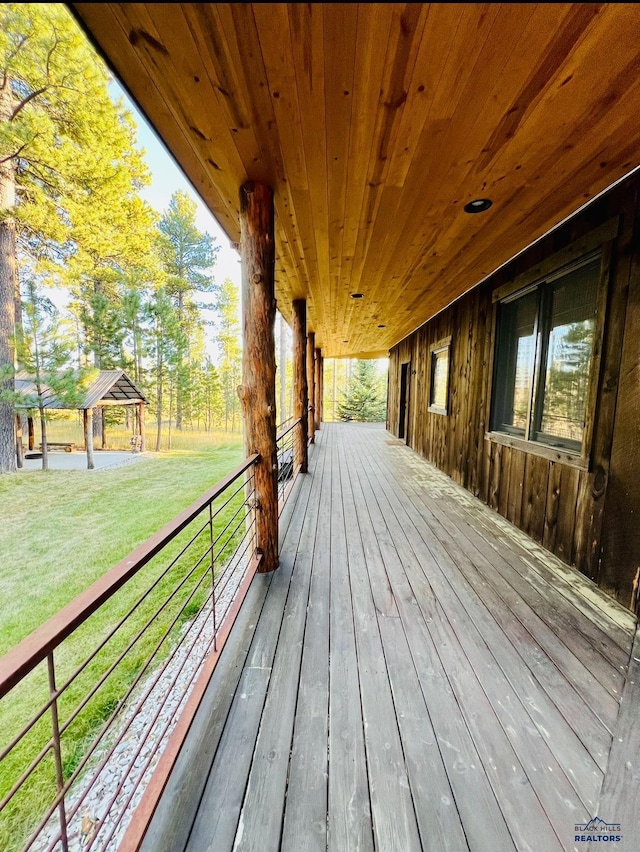 wooden deck featuring a gazebo and a lawn