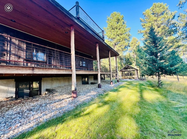 view of property exterior featuring a lawn and a gazebo