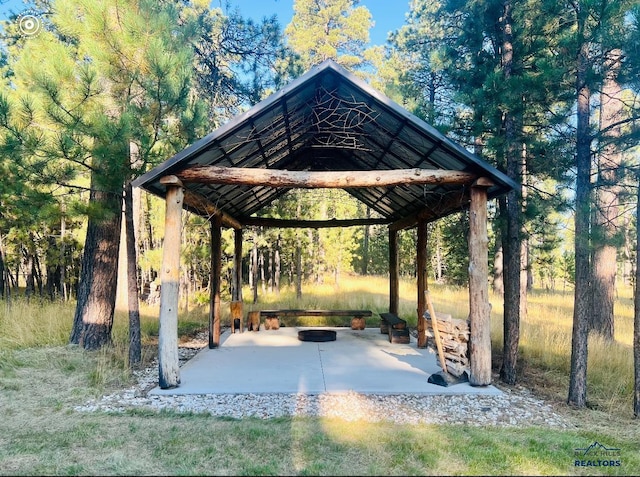 surrounding community featuring an outdoor fire pit and a gazebo