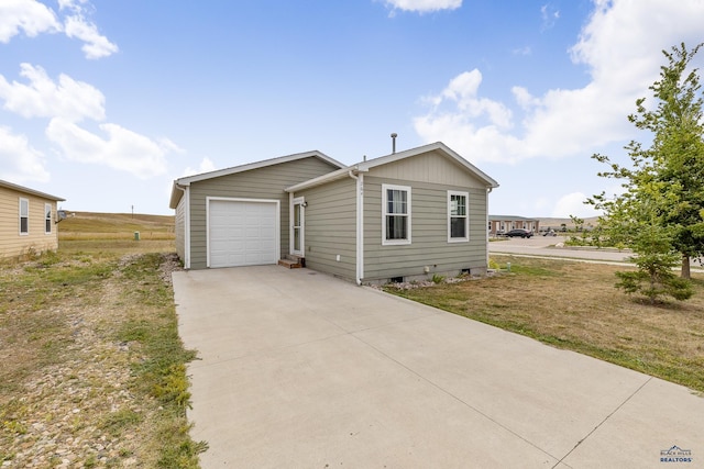 view of front of house featuring a garage and a front lawn