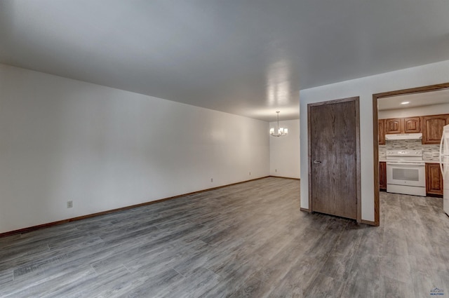 interior space featuring light wood-type flooring and an inviting chandelier