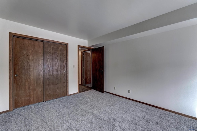 unfurnished bedroom with a closet and carpet floors