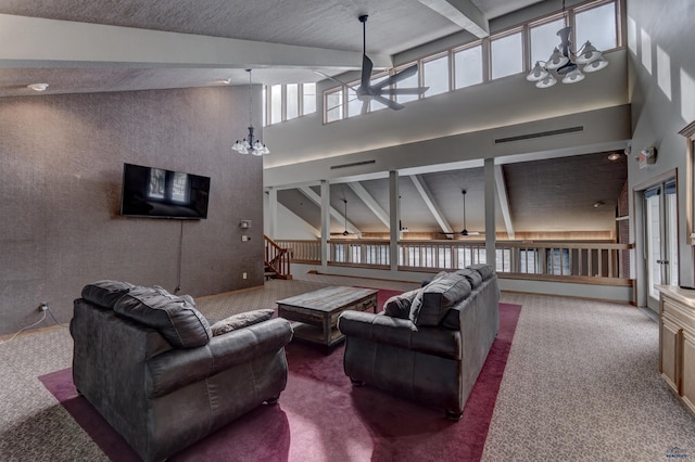 carpeted living room with ceiling fan with notable chandelier, high vaulted ceiling, and beam ceiling