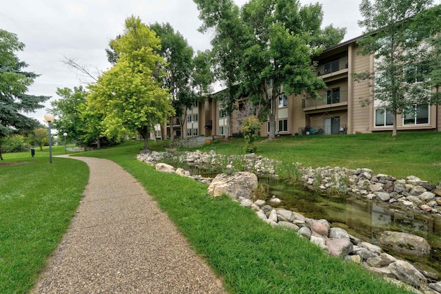 view of property's community with a lawn