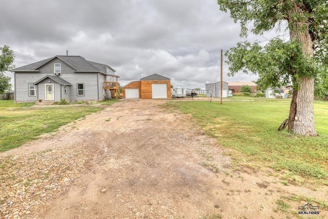 view of front facade with an outdoor structure, a garage, and a front yard