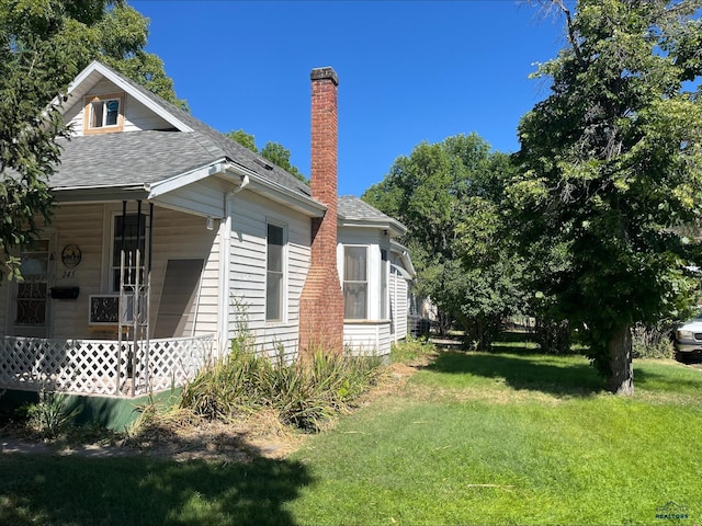 view of property exterior featuring a lawn