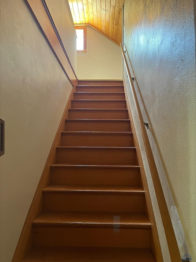 staircase with lofted ceiling