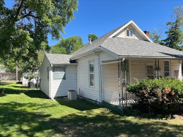 view of side of home with a lawn