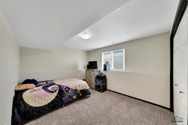 bedroom with a closet and carpet floors