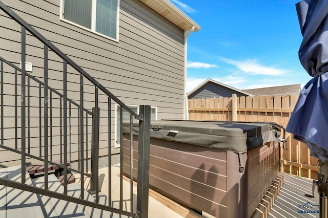 view of side of property with a hot tub