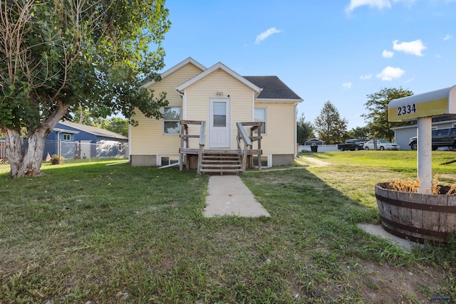 back of house with a yard