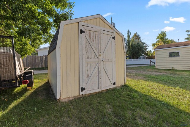 view of outbuilding featuring a lawn