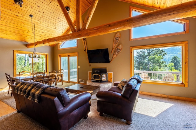 21169 Last Chance Trl, Lead, SD 57754 - living room with a wood stove, beamed ceiling, a chandelier, wood ceiling, and high vaulted ceiling