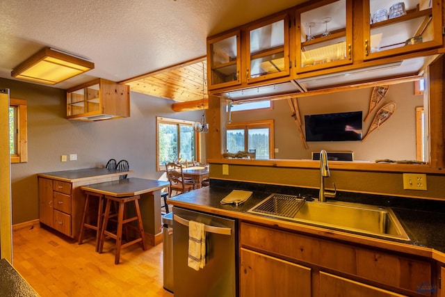21169 Last Chance Trl, Lead, SD 57754 - kitchen with dishwasher, a sink, brown cabinets, light wood finished floors, and glass insert cabinets