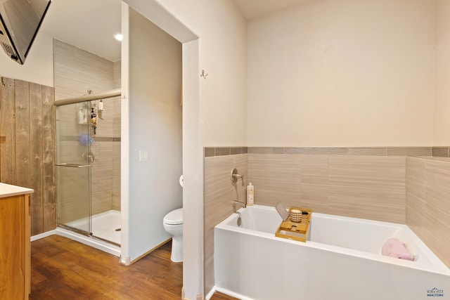 full bathroom with vanity, toilet, wood-type flooring, and shower with separate bathtub