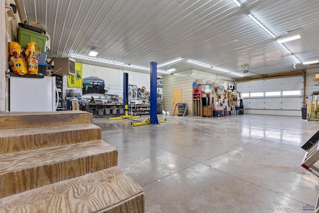 garage featuring white fridge and a workshop area