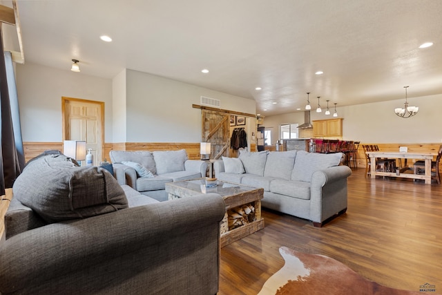 living room featuring hardwood / wood-style floors and a notable chandelier