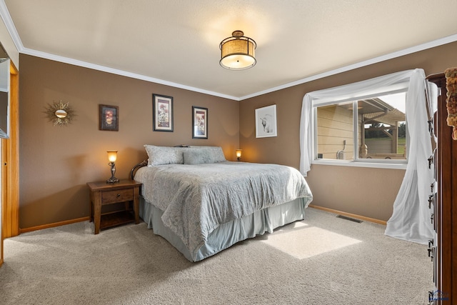 bedroom with crown molding and carpet floors