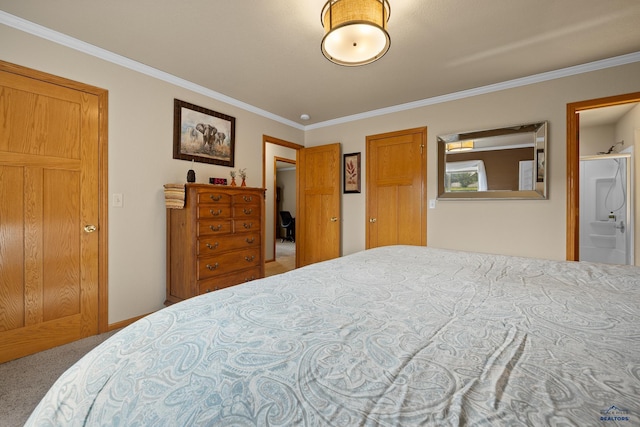 bedroom with carpet floors, ensuite bath, and ornamental molding