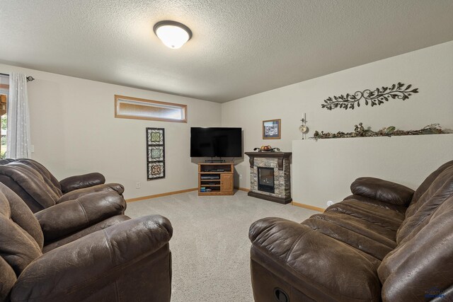 living room with light colored carpet, a textured ceiling, and a stone fireplace