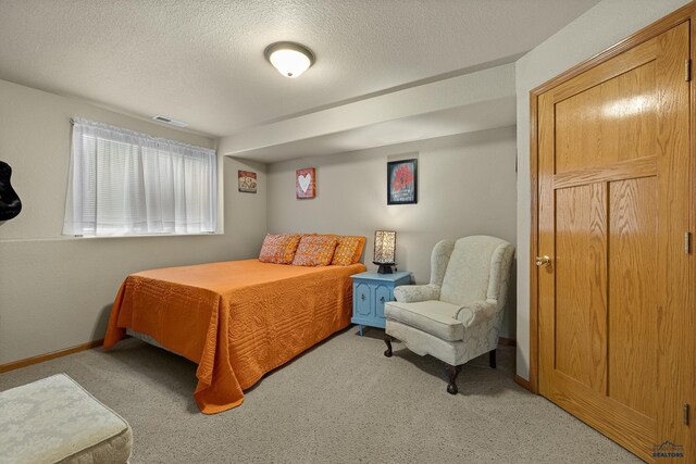 carpeted bedroom featuring a textured ceiling