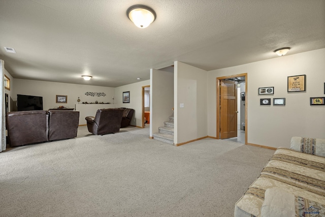 carpeted living room with a textured ceiling