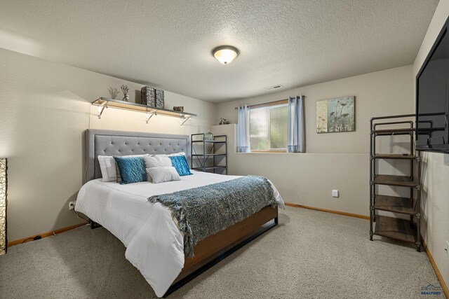 carpeted bedroom with a textured ceiling