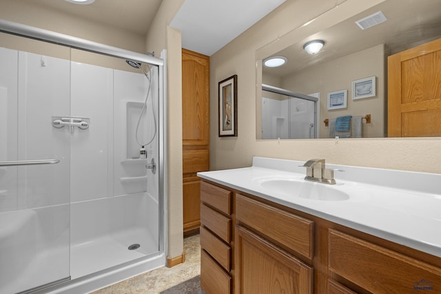 bathroom featuring an enclosed shower and vanity