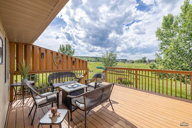 wooden deck with a fire pit and a yard